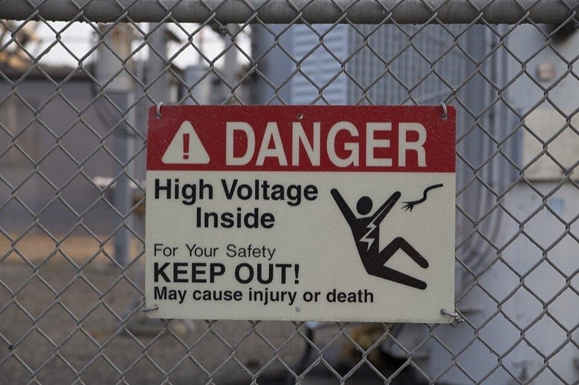 A danger sign on a fence: high voltage – keep out!