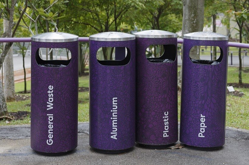 Bins for sorting rubbish into different materials: paper, plastic, aluminium and general waste.