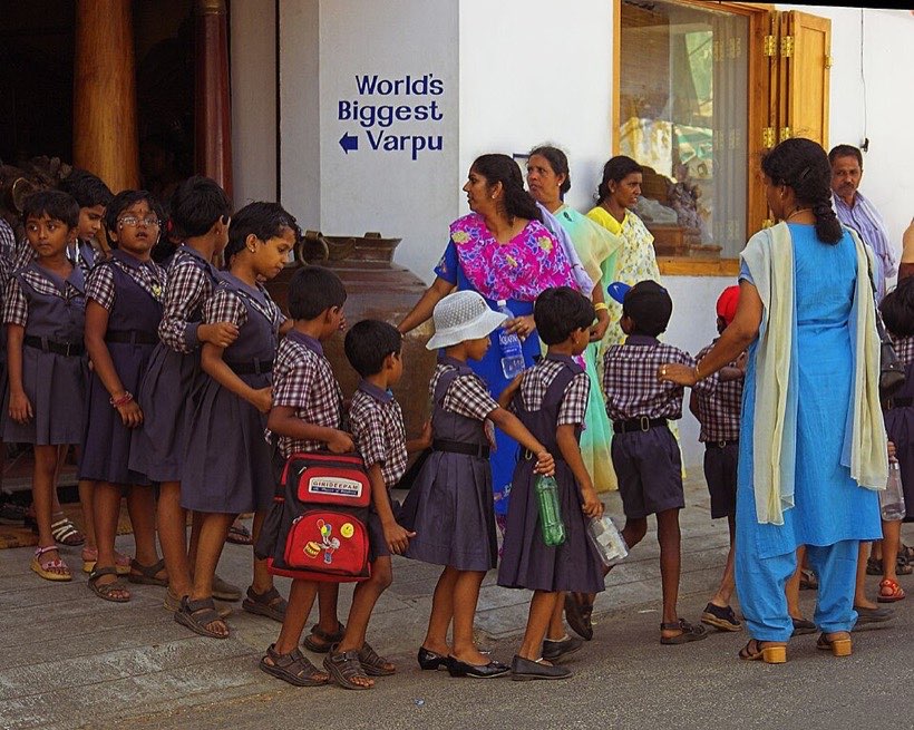 Children lining up in a queue. Who is first?