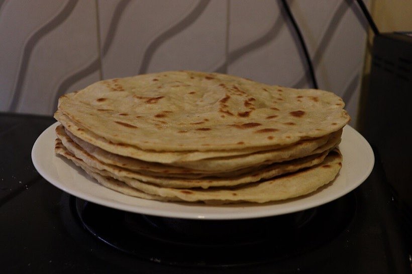 A pile of rotis. One roti can be torn into equal parts to share.