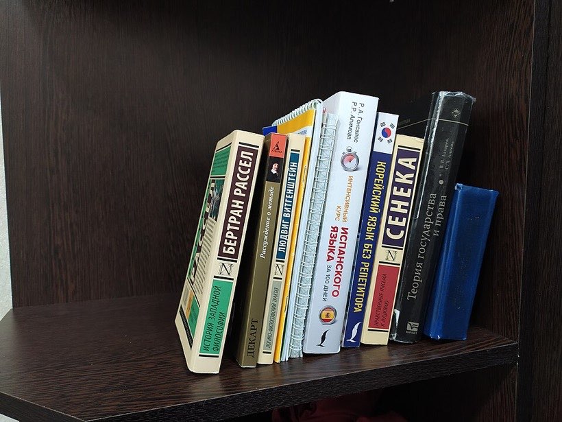 Books on a shelf: some above, some below.