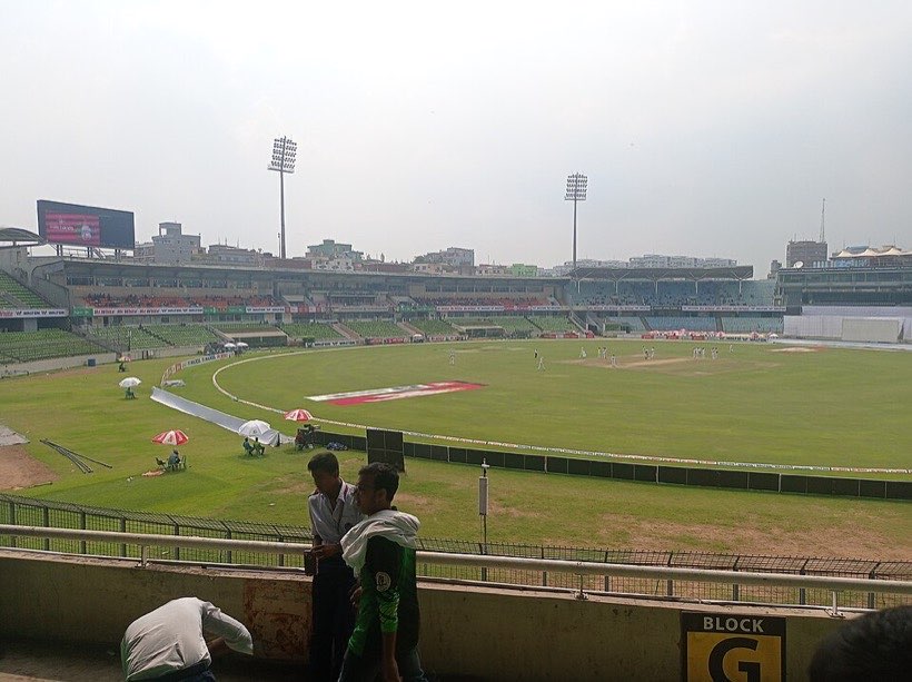 A cricket match in Dhaka. Scorers add the runs quickly in their heads.