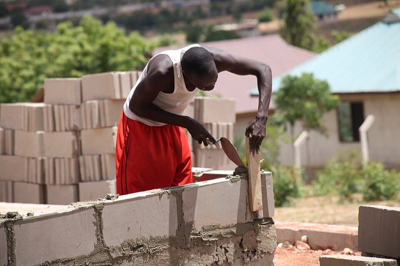 A builder laying bricks. Walls must meet at square corners.