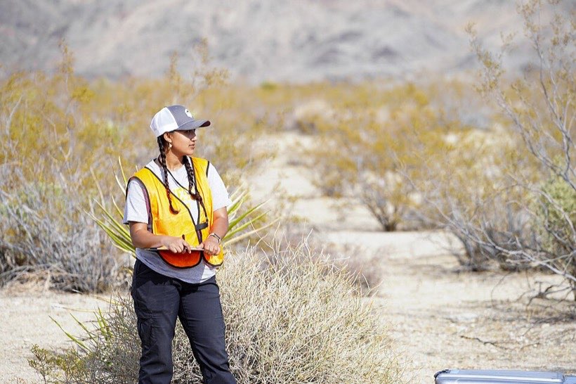 A learner records answers on a clipboard.